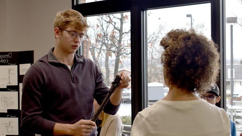 Jalen Kosko, Penn State DuBois freshman mechanical engineering student, presents the prototype for his group at the collaboration projects presentation