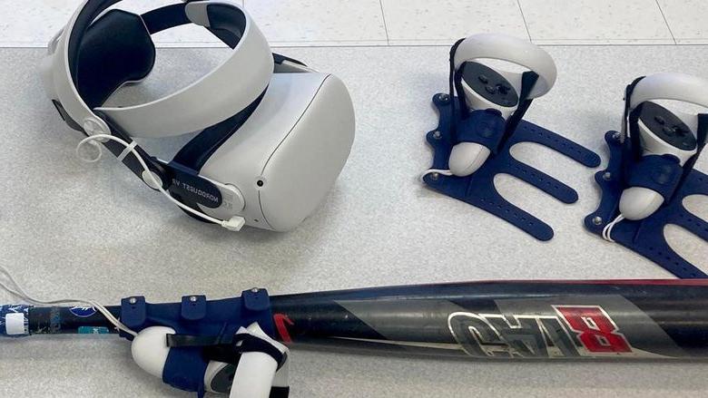 The virtual reality headset and controllers, 包括一个连在蝙蝠上的, that are used for baseball and softball hitting practice using software available through the NCPA LaunchBox, 由365英国上市杜波依斯提供动力.