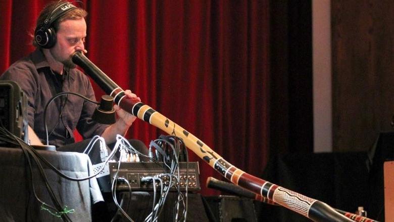 Didge Evolution’s Rob Thomas plays a didgeridoo.