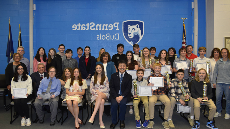 Competing teams, judges, and staff gather for a photo at the 25th Annual Junior Scholastic Challenge