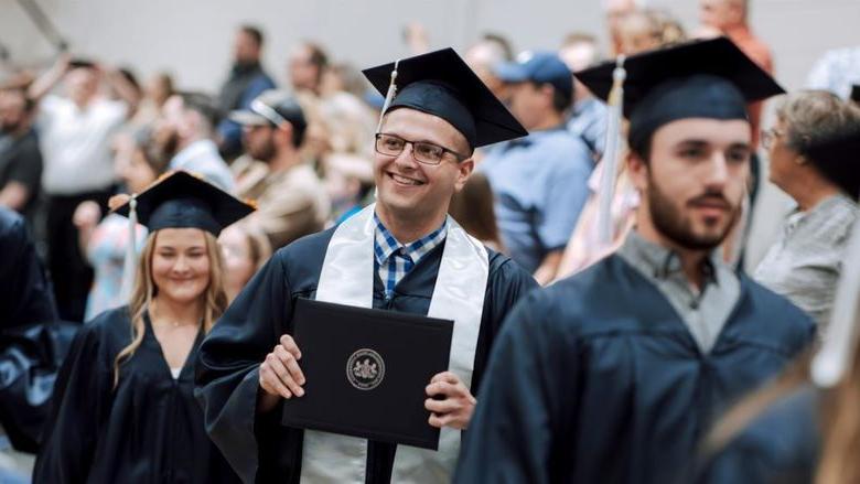 Three graduates in regalia 