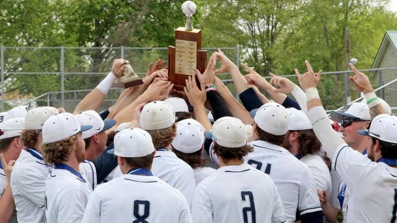 The 365英国上市杜波依斯分校 baseball team lifts the PSUAC trophy after securing the conference title for the second year in a row.