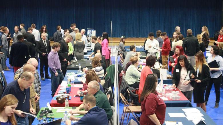 Jobseekers interact with employers during last year's career fair in the campus gymnasium.  