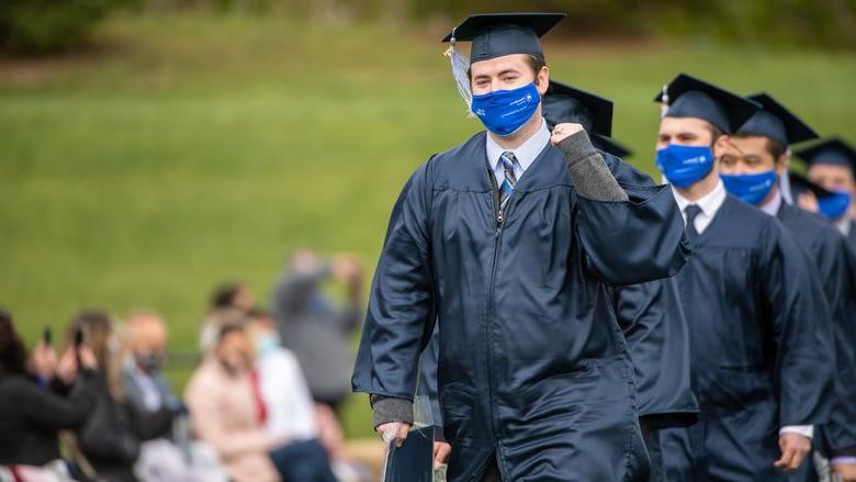 Penn State Behrend graduates celebrate as they leave the stadium at the conclusion of an outdoor ceremony on May 8.