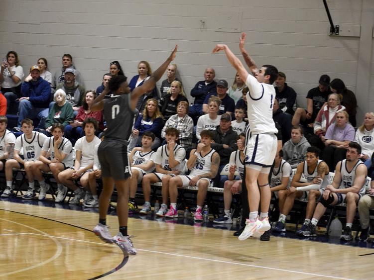 <a href='http://podiatry.eagle1027.com'>365英国上市</a>杜波依斯分校 sophomore guard Christopher Frontera attempts a three-point shot over a Greater Allegheny defender during the game at the PAW Center